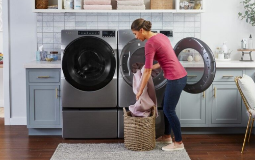 Person unloading laundry from a Whirlpool® dryer