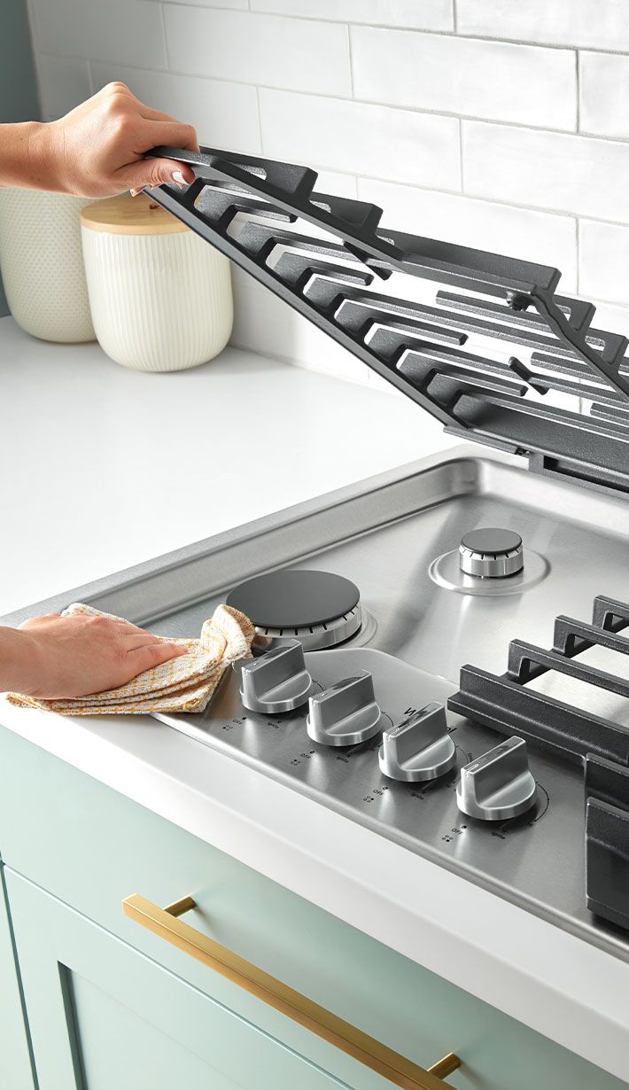 Des tables de cuisson au gaz avec des grilles qui se soulèvent pour faciliter le nettoyage.